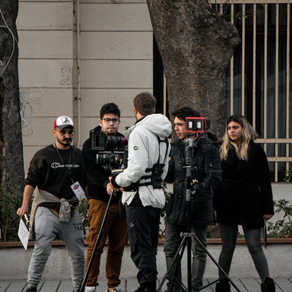 A group of filmmakers setting up equipment on a street in Istanbul, capturing a scene.