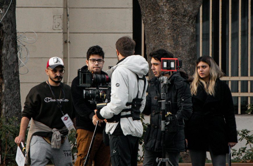 A group of filmmakers setting up equipment on a street in Istanbul, capturing a scene.